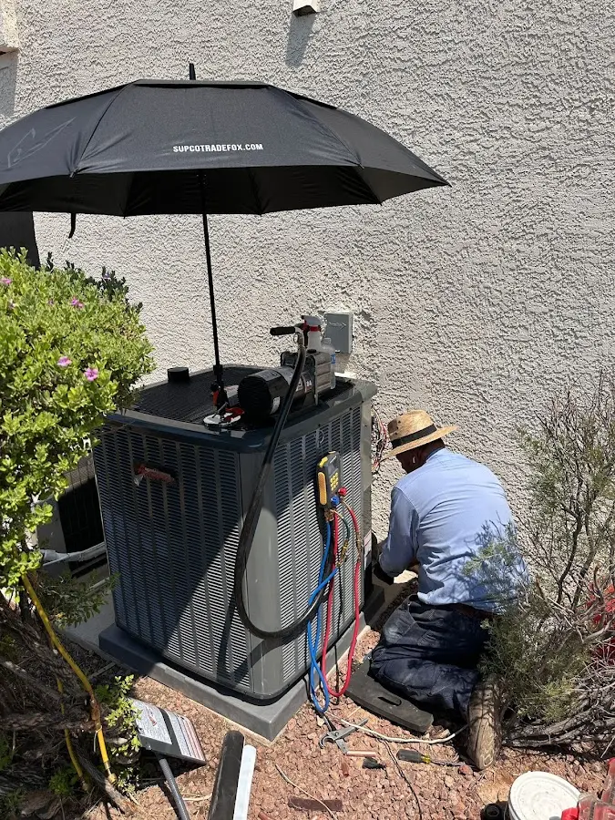 HVAC technician performing outdoor AC maintenance in Nutley